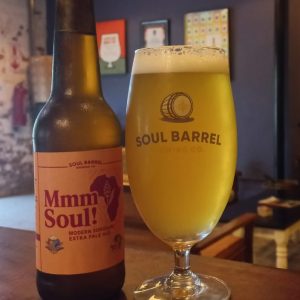 Mmm Soul sorghum beer bottle and poured glass on display
